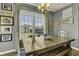Charming dining room with a rustic wooden table, bench seating, and natural light at 10326 Haag Dr, Brownsburg, IN 46112
