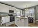Well-equipped kitchen with white cabinets, stainless steel appliances, and a cozy eat-in dining area at 10326 Haag Dr, Brownsburg, IN 46112