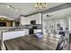 Well-lit kitchen with white cabinets, stainless steel appliances, and an adjacent dining area at 10326 Haag Dr, Brownsburg, IN 46112