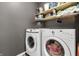 Bright laundry room with a washer, dryer, and overhead storage shelves at 10326 Haag Dr, Brownsburg, IN 46112
