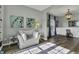 Cozy living room featuring hardwood floors and a white sofa accented with a patterned blue rug at 10326 Haag Dr, Brownsburg, IN 46112