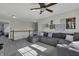 Spacious living room with a large gray sectional, plush carpeting, and decorative wall art at 10326 Haag Dr, Brownsburg, IN 46112