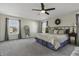 Serene main bedroom with two large windows, a metal bed frame, and neutral décor at 10326 Haag Dr, Brownsburg, IN 46112