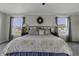 Bright main bedroom featuring a large bed, bedside tables, and view of the neighborhood at 10326 Haag Dr, Brownsburg, IN 46112
