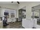 Well-lit sunroom with exercise equipment, backyard views, and a large chest freezer at 10326 Haag Dr, Brownsburg, IN 46112