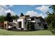Back of modern home featuring natural wood accents and professionally landscaped grounds at 10440 Somerford Rdg, Zionsville, IN 46077