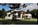 Landscaped modern home featuring natural wood and covered outdoor living area at 10440 Somerford Rdg, Zionsville, IN 46077