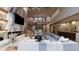 Open-concept living area with fireplace, staircase, and modern furnishings at 10440 Somerford Rdg, Zionsville, IN 46077