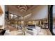Open-concept living area with fireplace, staircase, modern furnishings, and bright light at 10440 Somerford Rdg, Zionsville, IN 46077