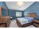 Well-lit bedroom boasts ample natural light, rustic wood furniture, and neutral carpeting at 1057 Timber Creek Dr # 12, Carmel, IN 46032