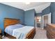 This bedroom features neutral carpeting, rustic wood furniture, and ensuite bathroom access at 1057 Timber Creek Dr # 12, Carmel, IN 46032