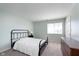 This bedroom features neutral carpeting, a double bed, and a white door at 1057 Timber Creek Dr # 12, Carmel, IN 46032