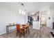 Bright dining area that features gray floors and modern light fixtures with access to the kitchen at 1057 Timber Creek Dr # 12, Carmel, IN 46032