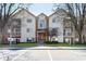 Exterior view of a three story condo with manicured lawn and ample parking in front at 1057 Timber Creek Dr # 12, Carmel, IN 46032