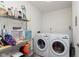 Laundry room equipped with appliances, storage shelves, and overhead lighting at 1057 Timber Creek Dr # 12, Carmel, IN 46032