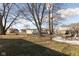 Spacious backyard with a patio and shed surrounded by mature trees and a lawn at 108 N Maple St, Pittsboro, IN 46167