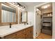 Bathroom with double vanity, wooden cabinets and an adjoining laundry room at 108 N Maple St, Pittsboro, IN 46167