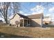 The side view of this home showcases a well-maintained lawn, convenient entryway, and simple architectural details at 108 N Maple St, Pittsboro, IN 46167