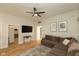 This living room features a mounted TV, comfortable sofa, and open access to a kitchen, creating a cozy and connected living space at 108 N Maple St, Pittsboro, IN 46167