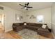 Inviting living room featuring a comfortable sectional sofa, stylish rug, and modern ceiling fan for a cozy ambiance at 108 N Maple St, Pittsboro, IN 46167