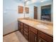 Bathroom with double sink vanity, granite countertop, and large mirror at 10831 Canoe Ct, Indianapolis, IN 46236