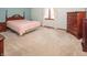 Bright bedroom with neutral carpet and matching wood furniture at 10831 Canoe Ct, Indianapolis, IN 46236