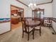 Traditional dining room features a wood table, china cabinet, and chandelier at 10831 Canoe Ct, Indianapolis, IN 46236