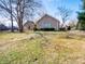A cozy stone home with a manicured front lawn and mature trees at 10831 Canoe Ct, Indianapolis, IN 46236