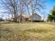 Charming stone-clad home featuring a well-maintained lawn and mature trees, offering curb appeal at 10831 Canoe Ct, Indianapolis, IN 46236