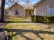 Charming stone home featuring manicured landscaping, mature trees, and inviting walkway at 10831 Canoe Ct, Indianapolis, IN 46236