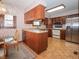 Bright kitchen with wood cabinets, stainless steel appliances, and a cozy breakfast nook at 10831 Canoe Ct, Indianapolis, IN 46236