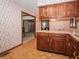 Charming kitchen with wooden cabinets and view into the dining room at 10831 Canoe Ct, Indianapolis, IN 46236