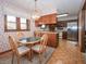 Open kitchen with dining nook, wooden cabinets, and modern stainless steel appliances at 10831 Canoe Ct, Indianapolis, IN 46236