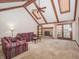 Spacious living room featuring vaulted ceilings, a stone fireplace, and access to the backyard at 10831 Canoe Ct, Indianapolis, IN 46236