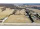 Wide aerial view of a rural property featuring multiple buildings and a large field at 1125 S Buffalo Hill Rd, Martinsville, IN 46151