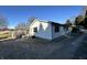 Side view of a well-kept home with dark shutters and a gravel driveway, blending comfort and practicality at 1125 S Buffalo Hill Rd, Martinsville, IN 46151