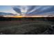 Scenic view of a vibrant sunset over a grassy field with trees in the distance at 1125 S Buffalo Hill Rd, Martinsville, IN 46151