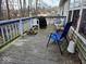 Relaxing back deck featuring weathered wood, a grill, outdoor seating, and scenic wooded views at 11521 Coastal Dr, Indianapolis, IN 46229
