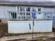 View of the back deck featuring weathered wood, outdoor seating, and a barbecue grill at 11521 Coastal Dr, Indianapolis, IN 46229