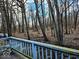 View of the wooded backyard from the deck with a light blue railing at 11521 Coastal Dr, Indianapolis, IN 46229