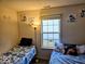 This bedroom shows two beds, art, and a large window at 11521 Coastal Dr, Indianapolis, IN 46229