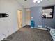Bedroom with blue accent wall, plush carpet and natural light at 11521 Coastal Dr, Indianapolis, IN 46229