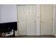 Bedroom shows multiple doors and a television at 11521 Coastal Dr, Indianapolis, IN 46229