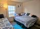 Bright bedroom features two beds and a window view at 11521 Coastal Dr, Indianapolis, IN 46229
