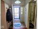 Open entryway view featuring a decorative storm door leading to the front yard and adjacent access to another room at 11521 Coastal Dr, Indianapolis, IN 46229