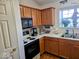 Efficient kitchen featuring wood cabinets, white countertops, and essential appliances at 11521 Coastal Dr, Indianapolis, IN 46229