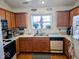 Well-lit kitchen with white countertops and wood cabinets with essential appliances at 11521 Coastal Dr, Indianapolis, IN 46229