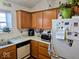 Bright kitchen featuring essential appliances, ample counter space and wood cabinets at 11521 Coastal Dr, Indianapolis, IN 46229