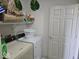 Functional laundry area with washer, dryer, and storage shelves at 11521 Coastal Dr, Indianapolis, IN 46229
