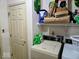 This laundry room includes a washer, dryer, and storage at 11521 Coastal Dr, Indianapolis, IN 46229